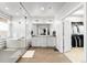 A modern bathroom with a walk-in shower, soaking tub, dual sinks, and an adjacent walk-in closet at 6614 S Vandriver Way, Aurora, CO 80016