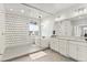 A luxurious bathroom featuring a soaking tub, walk-in shower, dual vanities, and attractive tiling at 6614 S Vandriver Way, Aurora, CO 80016