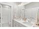 Bright bathroom featuring double sinks, large mirror, vanity, tile flooring and shower-tub combination at 6614 S Vandriver Way, Aurora, CO 80016