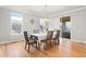 Formal dining room with hardwood floors, windows, and access to an outdoor patio at 6614 S Vandriver Way, Aurora, CO 80016
