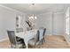 Formal dining room with seating for six and a modern chandelier at 6614 S Vandriver Way, Aurora, CO 80016