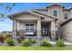 Inviting front porch of home features stone accents, railing, and swing, creating a cozy outdoor seating area at 6614 S Vandriver Way, Aurora, CO 80016