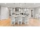 Bright, modern kitchen with stainless steel appliances, a large island, and bar stool seating at 6614 S Vandriver Way, Aurora, CO 80016