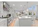Modern kitchen with stainless steel appliances, a large island, and bar stool seating at 6614 S Vandriver Way, Aurora, CO 80016