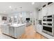 Open concept kitchen with stainless steel appliances, a center island, and an eat-in area at 6614 S Vandriver Way, Aurora, CO 80016
