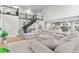 Open living room area with a staircase, and access to the kitchen and upstairs at 6614 S Vandriver Way, Aurora, CO 80016