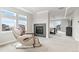 Spacious main bedroom with a fireplace, sitting chair, carpet and many windows at 6614 S Vandriver Way, Aurora, CO 80016