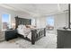 Bright main bedroom with large bed frame, white ceiling fan, and large windows with a mountain view at 6614 S Vandriver Way, Aurora, CO 80016