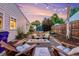 Cozy backyard with gravel, string lights, and a modern fire pit seating area for outdoor relaxation at 2530 S Knox Ct, Denver, CO 80219