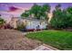 Charming home featuring a well-maintained lawn, flower beds and cozy deck, perfect for outdoor enjoyment at 2530 S Knox Ct, Denver, CO 80219
