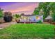 Backyard featuring a lush green lawn and cozy deck, creating a serene outdoor space at 2530 S Knox Ct, Denver, CO 80219