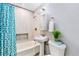 Compact bathroom featuring a shower-over-tub and modern fixtures at 2530 S Knox Ct, Denver, CO 80219