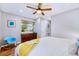 Cozy bedroom features a ceiling fan, wood floors, and natural lighting at 2530 S Knox Ct, Denver, CO 80219