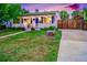 Charming home with a cozy front porch, wood fence, and inviting curb appeal at 2530 S Knox Ct, Denver, CO 80219