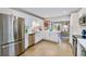 Well-lit kitchen featuring stainless steel appliances and white cabinetry at 2530 S Knox Ct, Denver, CO 80219