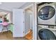Laundry area with stacked washer and dryer, conveniently located near the kitchen at 2530 S Knox Ct, Denver, CO 80219