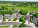 An aerial view of a residential neighborhood with well-maintained lawns and mature trees at 2011 Sundrop Trl, Highlands Ranch, CO 80126
