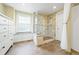 Bathroom features a glass shower with bench, neutral tiling, and natural light at 2011 Sundrop Trl, Highlands Ranch, CO 80126