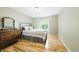 Bedroom with hardwood floors, a bed with decorative pillows, and natural light at 2011 Sundrop Trl, Highlands Ranch, CO 80126