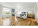 Bright bedroom featuring hardwood floors, fireplace, and white decor at 2011 Sundrop Trl, Highlands Ranch, CO 80126