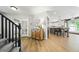 Inviting entryway with hardwood floors, an accent cabinet, and access to the kitchen at 2011 Sundrop Trl, Highlands Ranch, CO 80126