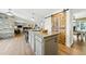 Open kitchen design with a large granite island, bar stools, and hardwood floors at 2011 Sundrop Trl, Highlands Ranch, CO 80126