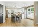Open kitchen featuring wood floors, granite countertops and a sliding barn door at 2011 Sundrop Trl, Highlands Ranch, CO 80126