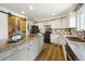 Modern kitchen with white cabinets, granite countertops, a black oven and a barn door at 2011 Sundrop Trl, Highlands Ranch, CO 80126