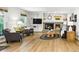 Cozy living room features a brick fireplace, built-in shelving, and wood flooring at 2011 Sundrop Trl, Highlands Ranch, CO 80126