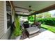 Covered patio with comfortable seating, overhead lighting, and view of the backyard at 2011 Sundrop Trl, Highlands Ranch, CO 80126