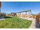 Landscaped backyard with pergola, fire pit, and green lawn at 261 Mesa Ave, Lochbuie, CO 80603