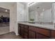 Bathroom boasts dual sinks, a walk-in closet, a soaking tub shower, and modern lighting at 261 Mesa Ave, Lochbuie, CO 80603