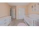 Neutral Bedroom showcases a white crib, closet, and dresser at 261 Mesa Ave, Lochbuie, CO 80603