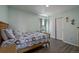 Bedroom with a bed, wooden floors, a window, and a closet with sliding doors at 261 Mesa Ave, Lochbuie, CO 80603