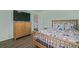 Bedroom featuring a wooden floor, a wooden bed, a window, and a wooden dresser at 261 Mesa Ave, Lochbuie, CO 80603