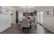 Dining area with neutral colored walls, a chandelier, and views of the adjacent kitchen at 261 Mesa Ave, Lochbuie, CO 80603