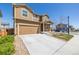 Two-story home with a concrete driveway and partially xeriscaped front yard at 261 Mesa Ave, Lochbuie, CO 80603