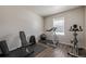 This home gym with wood floors features a treadmill, weight rack, exercise bike, and space for activities at 261 Mesa Ave, Lochbuie, CO 80603
