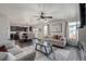 Open concept living room with a dining area and adjacent kitchen with dark wood cabinets at 261 Mesa Ave, Lochbuie, CO 80603