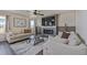 Comfortable living room featuring a stone accent wall with an electric fireplace and a ceiling fan at 261 Mesa Ave, Lochbuie, CO 80603