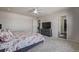 Primary bedroom features plush carpet, a ceiling fan, a closet, and a dresser with television at 261 Mesa Ave, Lochbuie, CO 80603