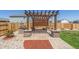 Outdoor pergola with built-in grill, stone columns, and patio at 261 Mesa Ave, Lochbuie, CO 80603