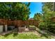 Fenced backyard with trees and garden boxes at 10345 Lions Heart, Lone Tree, CO 80124