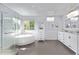 Bright and open bathroom featuring a soaking tub, walk-in shower, and dual vanity with modern lighting at 10345 Lions Heart, Lone Tree, CO 80124