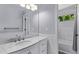 Bright bathroom features a vanity with stone countertop and a tiled shower at 10345 Lions Heart, Lone Tree, CO 80124