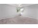 Spacious bedroom with gray carpet and large windows with lush outdoor views at 10345 Lions Heart, Lone Tree, CO 80124