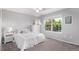 Bright bedroom features a large window, gray carpet, and a comfortable bed at 10345 Lions Heart, Lone Tree, CO 80124