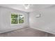 Serene bedroom features gray carpet, a ceiling fan, and a large window at 10345 Lions Heart, Lone Tree, CO 80124