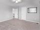 Bright bedroom features gray carpet, with views into hallway at 10345 Lions Heart, Lone Tree, CO 80124