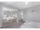 Cozy bedroom with gray carpet, closet with mirrored doors, and a view into the hallway at 10345 Lions Heart, Lone Tree, CO 80124